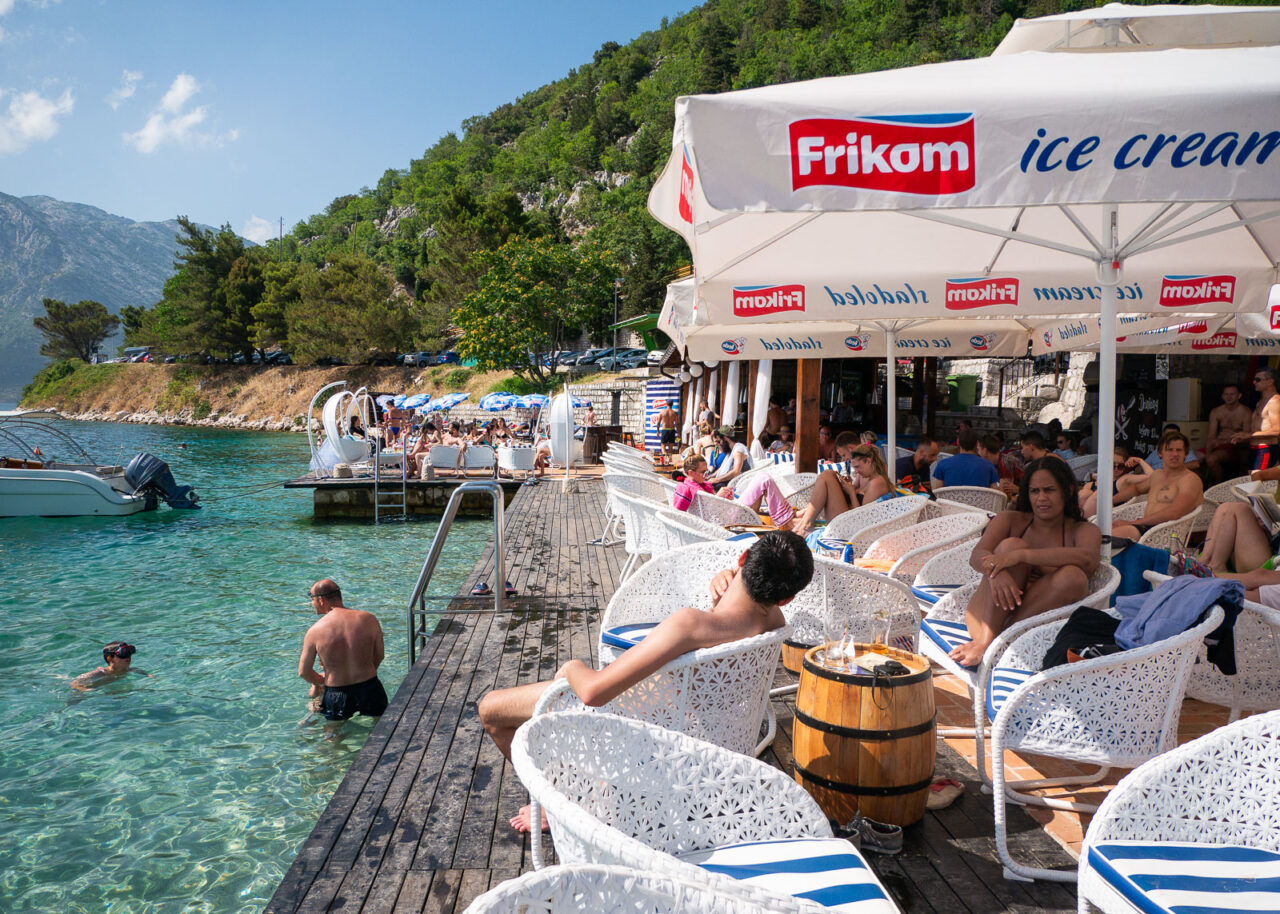 People relaxing on the deck at Pirate Bar in Perast, Montenegro